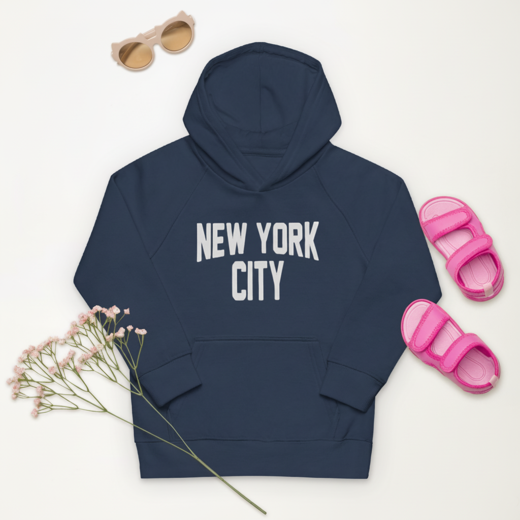Navy hoodie with 'New York City' text, pink sandals, sunglasses, and flowers on a white background